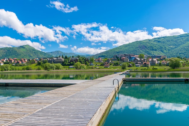 A picturesque mountain lake is located in a valley among the mountains