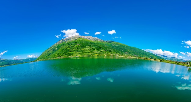 A picturesque mountain lake is located in a valley among the mountains