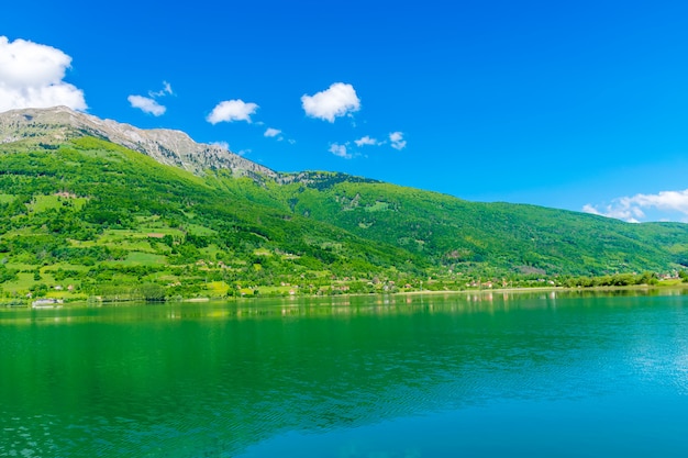 A picturesque mountain lake is located in a valley among the mountains.