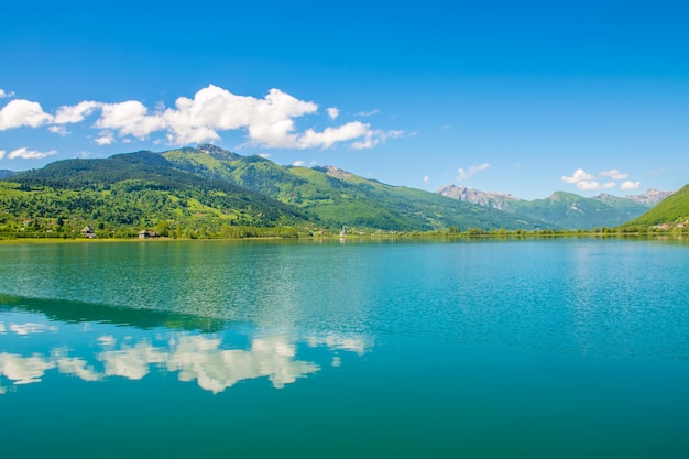 A picturesque mountain lake is located in a valley among the mountains.