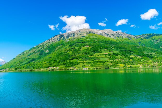 A picturesque mountain lake is located in a valley among the mountains