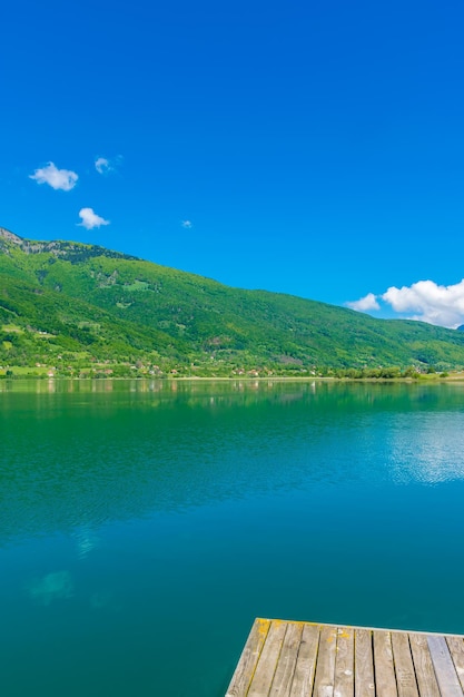 A picturesque mountain lake is located in a valley among the mountains