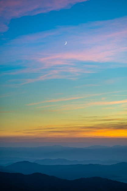 The picturesque mountain landscape on the sunrise background