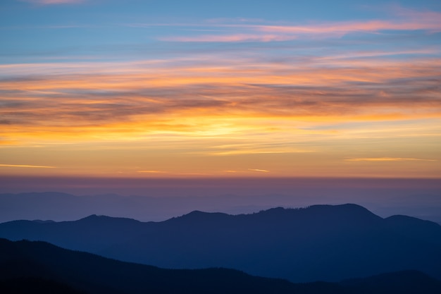 The picturesque mountain landscape on the sunset background