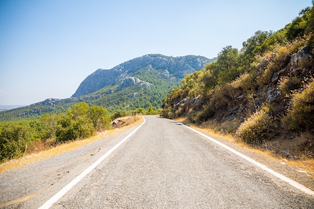 A picturesque narrow paved road in the Termessos National Park in Turkey.