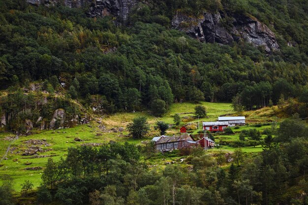 Picturesque Norway mountain village landscape nature view with majestic waterfall and mountains