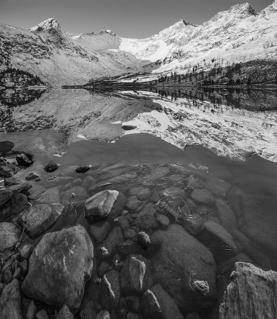 Picturesque reflection of snowcapped mountains in the lake black and white