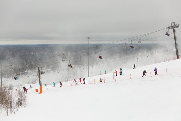 Picturesque scenery of people engaged in winter sports resort in Russia.