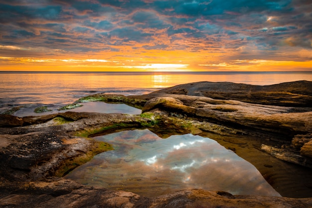 Picturesque sunrise over a rocky beach.