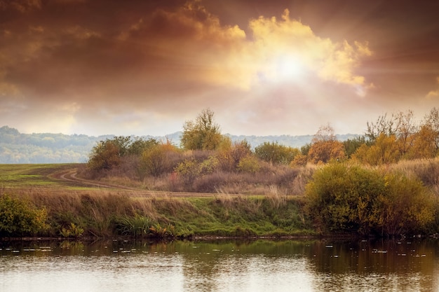 Picturesque sunset over the river in autumn