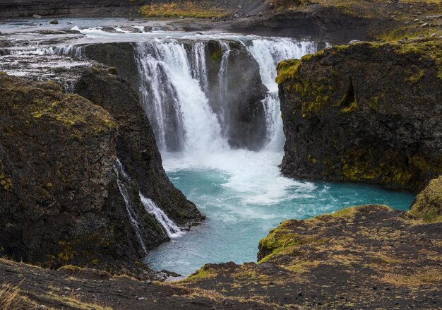 Picturesque waterfall Sigoldufoss autumn view Season changing in southern Highlands of Iceland