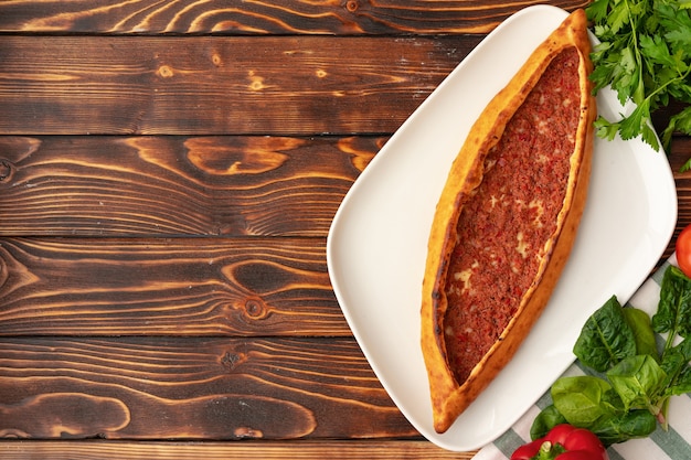 Pide  turkish baked bread on wooden table