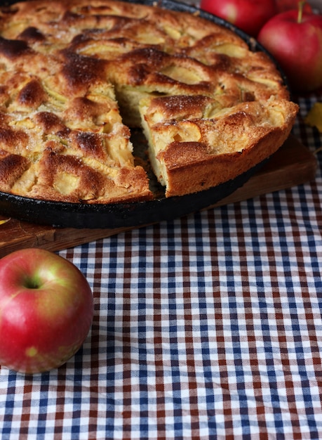 Pie of apples on the table. Still life, food. Empty space for text at the bottom.