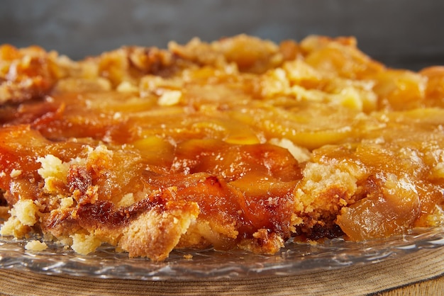 Pie baked with apricots on transparent plate