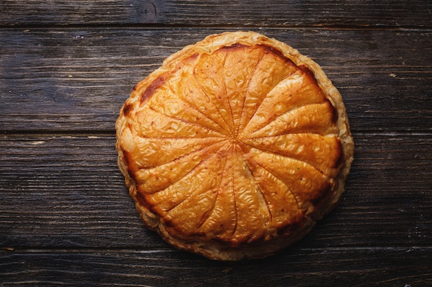 Pie cake. Traditional baked pastry food on rustic wooden table wall