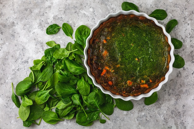 Pie with fish and spinach leaves