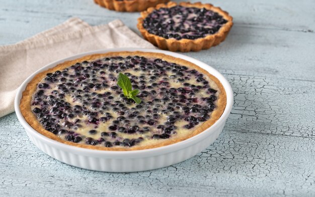 Pie with fresh blueberries on wooden table