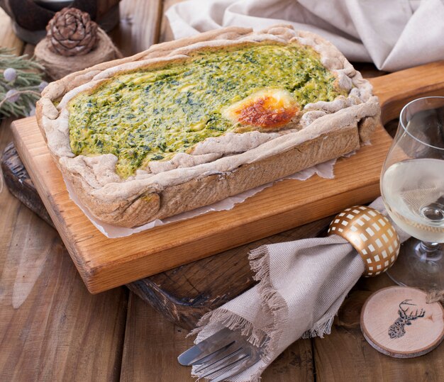 Пирог со шпинатом и сыром на деревянной доске