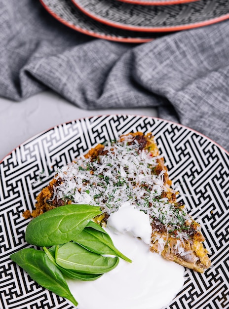 Pie with spinach on plate top view