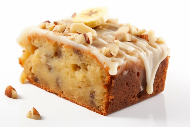 A piece of banana cake with icing and nuts on top.