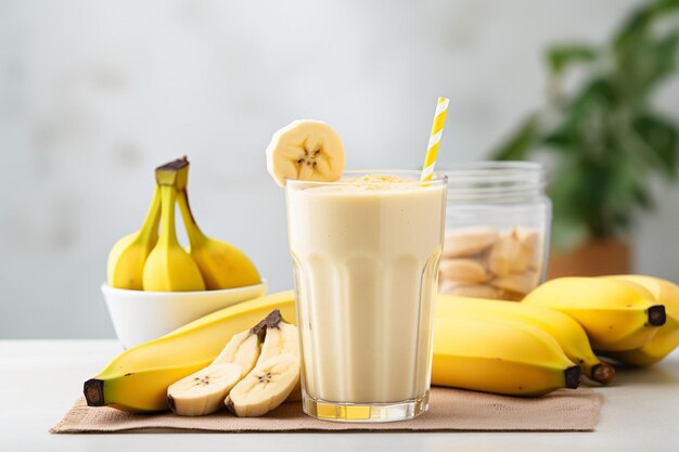 Photo a piece of banana in a glass with a banana smoothie
