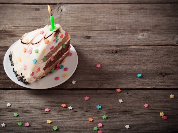 Piece of Birthday Cake on wooden background