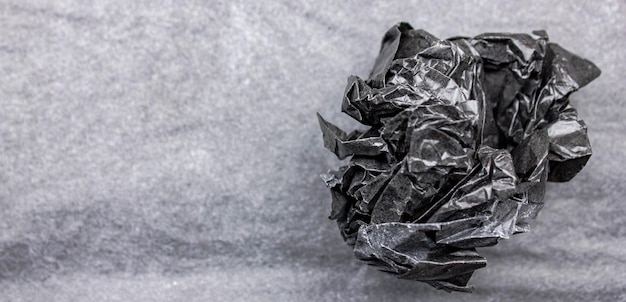 A piece of black paper crumpled piece of black papercrumpled\
black paper ballnatural textured crumpled sheet crumpled dark paper\
ball