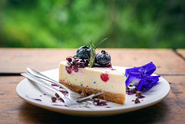 Piece of Blueberry Cheesetasty cheesecake dessert on table wooden in Coffee Shop