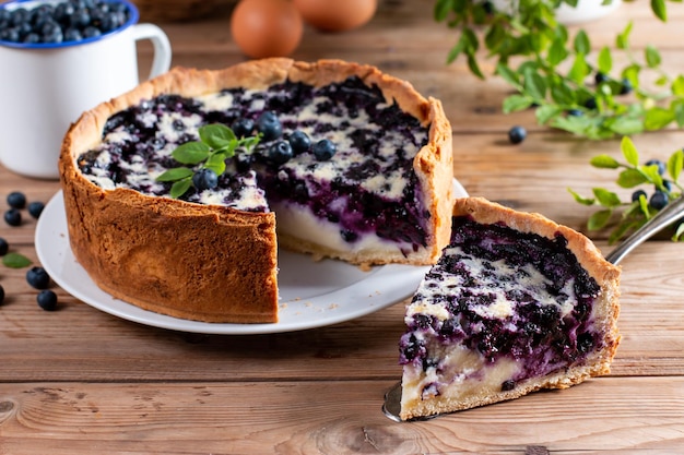 A piece of blueberry pie on wooden table