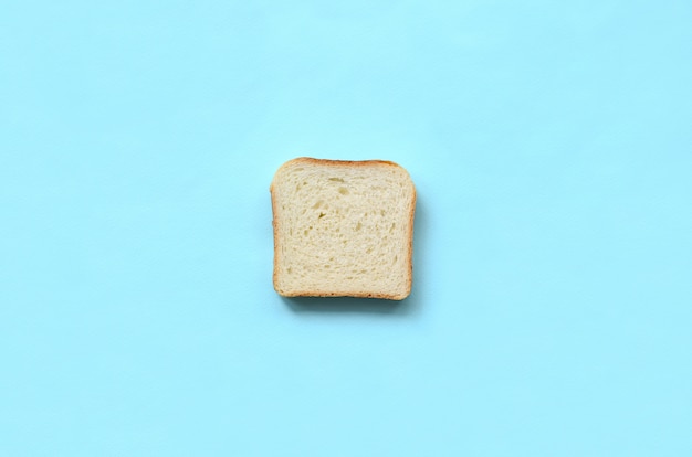 A piece of bread lies on texture background 