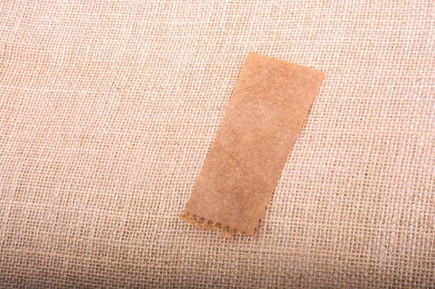 Piece of brown paper on a wooden background