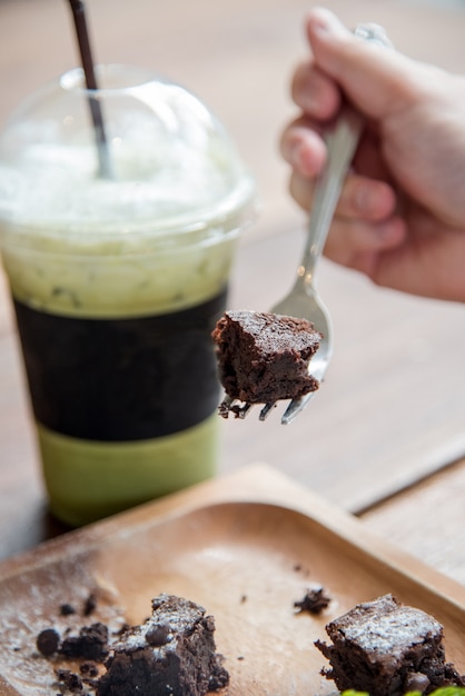 A piece of brownie cake with green tea drink