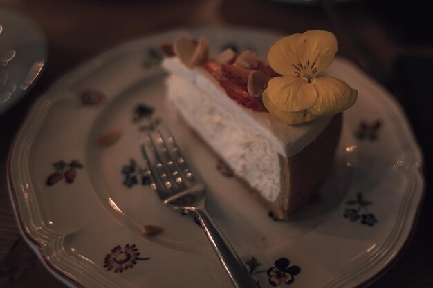 Piece of cake Cheesecake with berries and pistachios. Dessert with fruits. Vintage style.