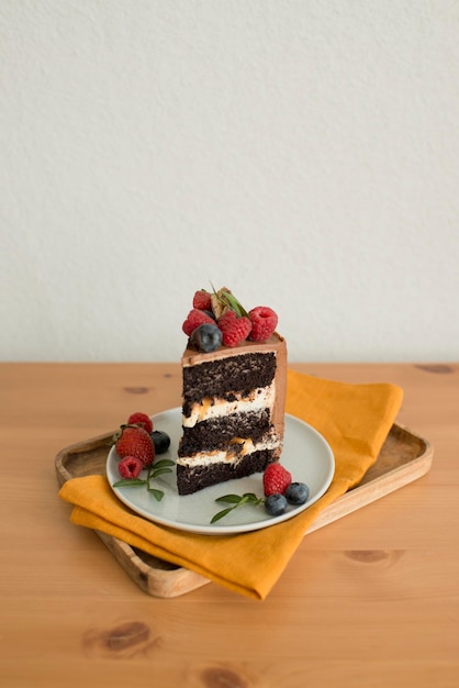 A piece of cake decorated with berries on a plate