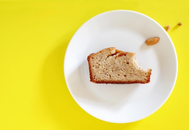 A piece of cake on a plate with a piece of bread on it