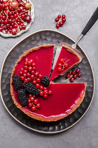 Foto un pezzo di torta con sopra dei frutti di bosco