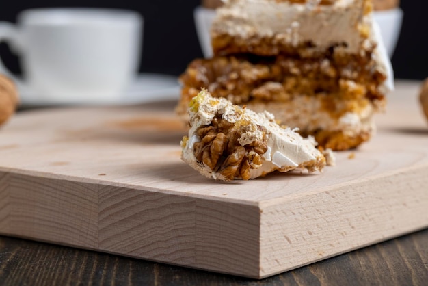A piece of cake with buttercream and walnuts