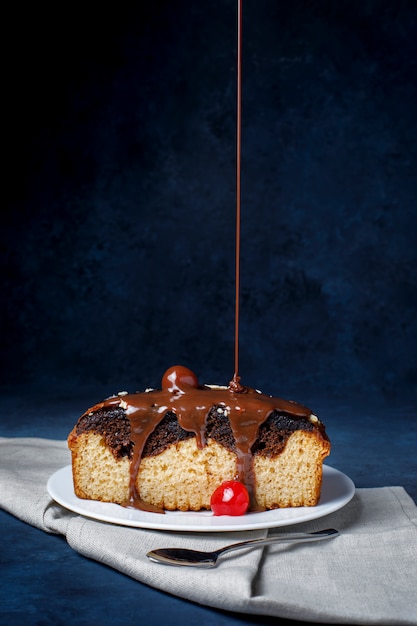 Piece of cake with chocolate and cherry