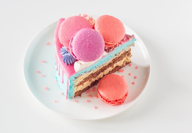 Piece of cake with pink and blue decor on white plate