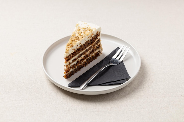 Photo a piece of carrot pie on a white plate a delicious dessert on the table with a beige tablecloth