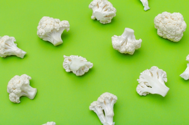 Piece of cauliflower isolated on green background