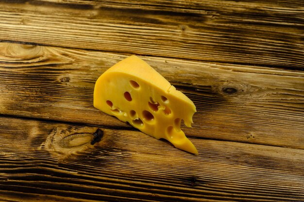 Piece of cheese on rustic wooden table