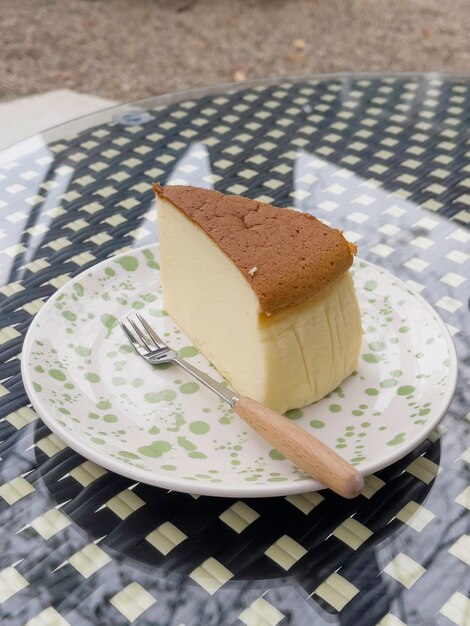 Piece of cheesecake serving in the garden