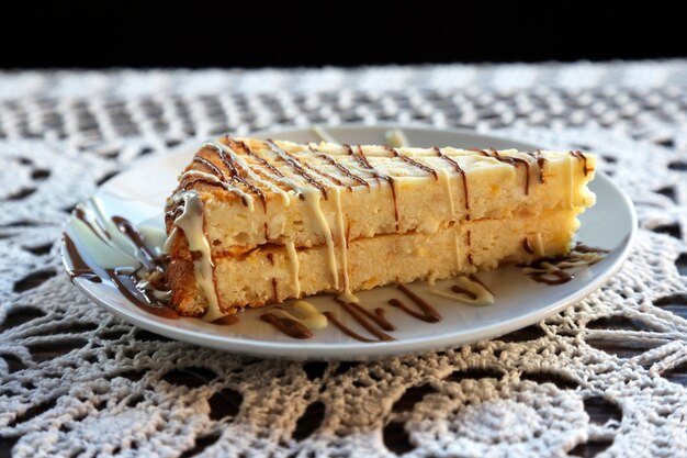 Piece of cheesecake with cream on a plate