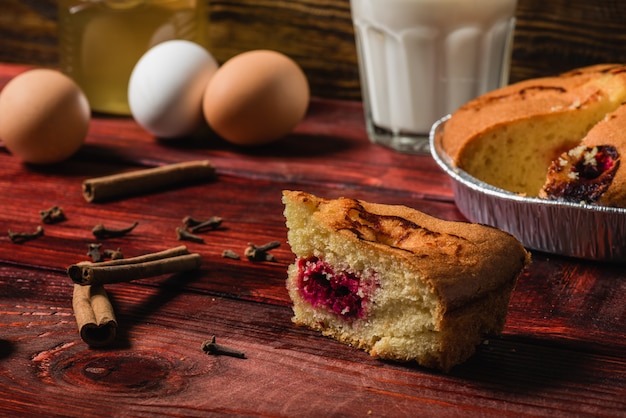 Piece of cherry cake on redwood table