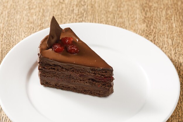 Piece of chocolate cake with cherries