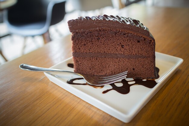 Foto pezzo di torta al cioccolato con sciroppo di cioccolato caldo