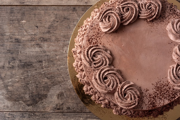 Piece of chocolate truffle cake on wooden table