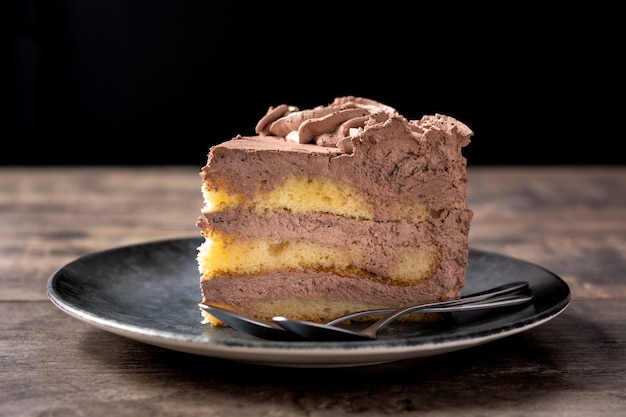 Piece of chocolate truffle cake on wooden table