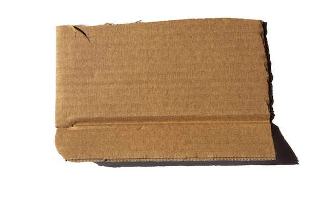 Photo a piece of corrugated cardboard insulated on a white background cardboard texture with a ragged edge